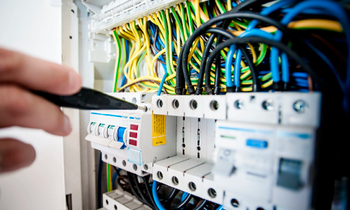 hand working on the home electrical panel