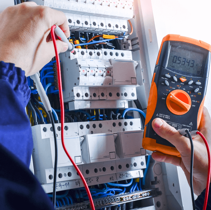 A person checking electrical panel with a device