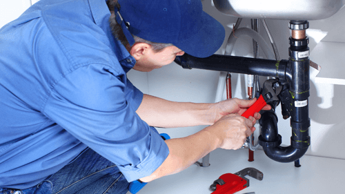 Picture of a male professional plumber fixing a sink pipe