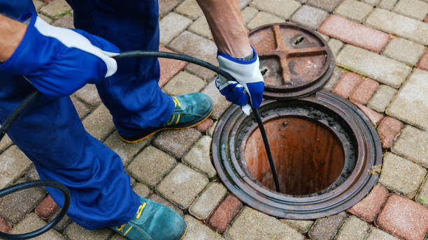 sewer cleaning service - worker clean a clogged drainage with hydro jetting